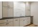 Close-up of a bar with shaker cabinets, black countertop and a marble-look tile backsplash at 912 Oak Dr, Woodstock, GA 30189