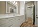 Bathroom featuring shaker cabinets, silver hardware, a large mirror and neutral walls at 912 Oak Dr, Woodstock, GA 30189