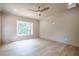 A well-lit bedroom features wood floors, a window, and a ceiling fan at 912 Oak Dr, Woodstock, GA 30189