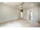 A bright bedroom features wood floors, a ceiling fan, and multiple doorways at 912 Oak Dr, Woodstock, GA 30189