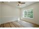 Bedroom with hardwood floors, ceiling fan and a large picture window with backyard views at 912 Oak Dr, Woodstock, GA 30189