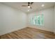 Bright bedroom features wood-look flooring, a ceiling fan and view to outdoors at 912 Oak Dr, Woodstock, GA 30189