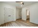 Bright bedroom features a ceiling fan, closet doors, and an open doorway to a dressing room or closet at 912 Oak Dr, Woodstock, GA 30189