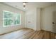 Bright bedroom featuring hardwood floors, recessed lighting, ceiling fan and a view of the trees at 912 Oak Dr, Woodstock, GA 30189