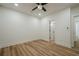 Bright bedroom with hardwood floors, recessed lighting, ceiling fan and a white door to an ensuite at 912 Oak Dr, Woodstock, GA 30189