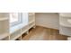 A bright walk-in closet features built-in shelves, window and wood laminate flooring at 912 Oak Dr, Woodstock, GA 30189