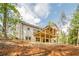 New two story home exterior with a backyard deck is landscaped with a freshly graded lawn at 912 Oak Dr, Woodstock, GA 30189