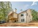 Back of new two story home features a deck that is partially covered with a stained wood ceiling at 912 Oak Dr, Woodstock, GA 30189
