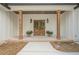 Charming front porch featuring wooden pillars, double doors, and brick flooring, creating a welcoming entrance at 912 Oak Dr, Woodstock, GA 30189
