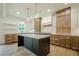 A modern kitchen featuring a large island, stainless appliances, and custom wood cabinets at 912 Oak Dr, Woodstock, GA 30189