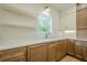 A bright kitchen features wood cabinets, white countertop and stainless steel faucet at 912 Oak Dr, Woodstock, GA 30189