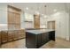 A modern kitchen features an island with a white countertop and wood cabinets at 912 Oak Dr, Woodstock, GA 30189