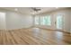 Bright living room featuring hardwood floors, recessed lighting, ceiling fan and views of nature through windows and a glass door at 912 Oak Dr, Woodstock, GA 30189