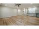 Open living room with hardwood floors, recessed lighting, ceiling fan and bar with shaker cabinets and a tile backsplash at 912 Oak Dr, Woodstock, GA 30189