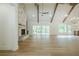 Spacious living room with high ceilings, wood beams, stone fireplace, and access to back deck at 912 Oak Dr, Woodstock, GA 30189
