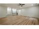 Spacious living room featuring hardwood floors, recessed lighting, ceiling fan and a bar with shaker cabinets and a tile backsplash at 912 Oak Dr, Woodstock, GA 30189
