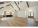 Open concept floor plan features hardwood floors, wood beams and easy access to kitchen at 912 Oak Dr, Woodstock, GA 30189
