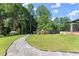 Lush backyard featuring a stone pathway, manicured lawn, playset, and privacy fence at 1336 Azalea Dr, Lawrenceville, GA 30043