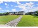 Expansive backyard featuring a stone pathway leading to the luxurious home, playground, and outdoor amenities at 1336 Azalea Dr, Lawrenceville, GA 30043