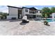 Luxurious backyard featuring a pool, spa, and modern seating with stone pavers at 1336 Azalea Dr, Lawrenceville, GA 30043