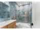 Luxurious bathroom showcasing elegant blue tile, modern fixtures, and a glass-enclosed shower for a spa-like experience at 1336 Azalea Dr, Lawrenceville, GA 30043