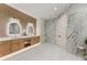 Elegant bathroom with double sinks, wood cabinets, and beautiful marble accent wall at 1336 Azalea Dr, Lawrenceville, GA 30043