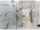 Bathroom featuring marble tile, glass enclosed walk-in shower with matte black fixtures at 1336 Azalea Dr, Lawrenceville, GA 30043