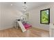 Bright bedroom with a unique custom-built bunk bed with a slide, hardwood floors, and black framed windows at 1336 Azalea Dr, Lawrenceville, GA 30043