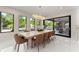 Elegant dining room with a large table, contemporary chandelier, and view of the outdoor pool at 1336 Azalea Dr, Lawrenceville, GA 30043