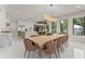 Open-concept dining area with stylish lighting, a wooden table, and seamless transition to the kitchen at 1336 Azalea Dr, Lawrenceville, GA 30043