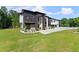 Modern home featuring black stone accents, a white facade, large windows, and a sprawling green lawn at 1336 Azalea Dr, Lawrenceville, GA 30043