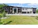 Modern home featuring black stone accents, a white facade, large windows, and manicured landscaping at 1336 Azalea Dr, Lawrenceville, GA 30043