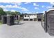Modern home with black stone accents, white facade, and a large driveway with gated entrance at 1336 Azalea Dr, Lawrenceville, GA 30043