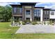Modern home featuring black stone accents, a white facade, large windows, and professional landscaping at 1336 Azalea Dr, Lawrenceville, GA 30043