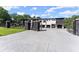 Modern home with black stone accents, white facade, and a large driveway with gated entrance at 1336 Azalea Dr, Lawrenceville, GA 30043