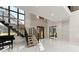 Bright foyer with a modern staircase, large windows, and a sleek piano adding elegance to the home's entrance at 1336 Azalea Dr, Lawrenceville, GA 30043