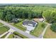 Aerial view of landscaped front yard and modern home with manicured lawn and long driveway at 1336 Azalea Dr, Lawrenceville, GA 30043