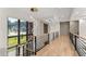 Bright hallway with modern railing and light fixture, offering serene views from expansive windows at 1336 Azalea Dr, Lawrenceville, GA 30043