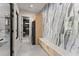 Hallway featuring modern design, marble wall, wood cabinets and view to the summer kitchen and bathroom at 1336 Azalea Dr, Lawrenceville, GA 30043
