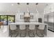 Modern kitchen with a marble island, white cabinets, stainless steel appliances, and pendant lights at 1336 Azalea Dr, Lawrenceville, GA 30043