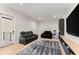 Inviting living room featuring a plush leather couch and large flat screen television at 1336 Azalea Dr, Lawrenceville, GA 30043
