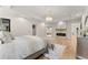 Bright bedroom features hardwood floors, a modern fireplace, chandelier and access to the ensuite at 1336 Azalea Dr, Lawrenceville, GA 30043