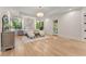 Spacious bedroom features hardwood floors, ample natural light, chandelier and accent wall at 1336 Azalea Dr, Lawrenceville, GA 30043