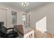 Bright office featuring hardwood floors, a modern desk, and an ensuite bathroom at 1336 Azalea Dr, Lawrenceville, GA 30043