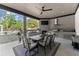 Stylish outdoor kitchen and dining area under a covered patio overlooking the pool and backyard at 1336 Azalea Dr, Lawrenceville, GA 30043
