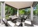 Cozy covered patio with comfortable seating, offering views of the serene backyard at 1336 Azalea Dr, Lawrenceville, GA 30043