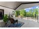 Relaxing covered patio with lounge seating and a beautiful view of the wooded property at 1336 Azalea Dr, Lawrenceville, GA 30043