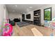 Spacious playroom with a comfortable couch and built-in shelving for toys and books at 1336 Azalea Dr, Lawrenceville, GA 30043
