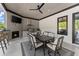 A covered summer kitchen featuring a grill, fireplace, tv and barstool seating, perfect for outdoor gatherings at 1336 Azalea Dr, Lawrenceville, GA 30043