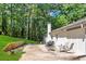 Private backyard with a patio perfect for grilling and outdoor dining, surrounded by lush trees and greenery at 2418 Bolling Brook Sw Dr, Atlanta, GA 30311